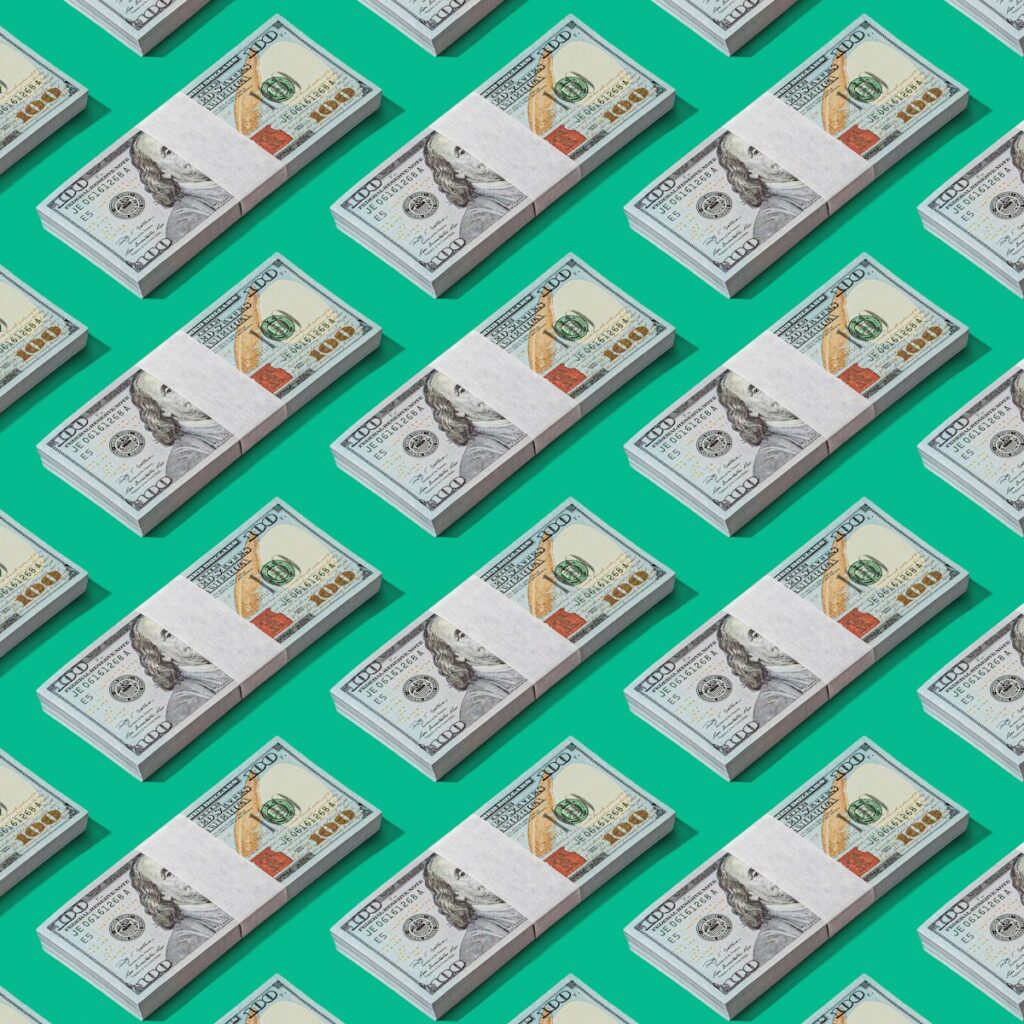 a lot of money sitting on top of a green surface