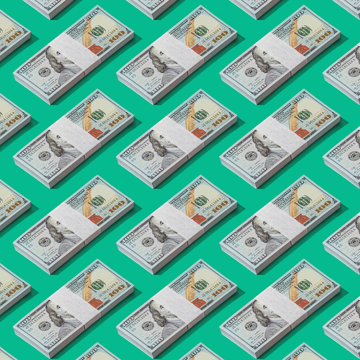 a lot of money sitting on top of a green surface